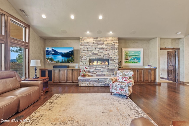 1122 S Four Winds Rd, Coeur Dalene, ID 83814 - living area featuring visible vents, dark wood-style flooring, a stone fireplace, recessed lighting, and lofted ceiling