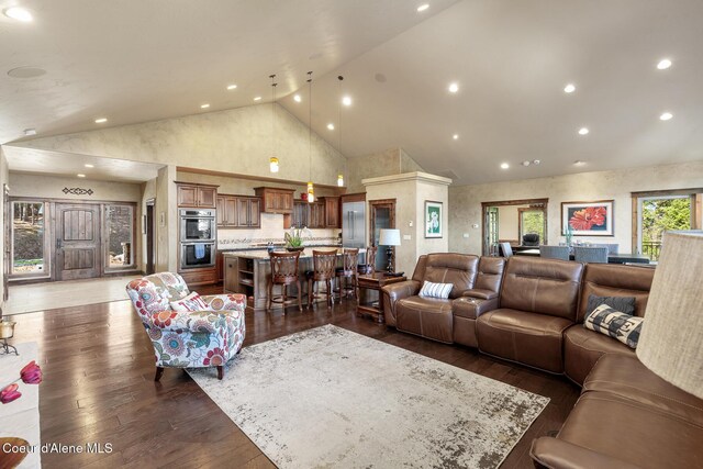 1122 S Four Winds Rd, Coeur Dalene, ID 83814 - living room with high vaulted ceiling, dark wood-style flooring, and recessed lighting