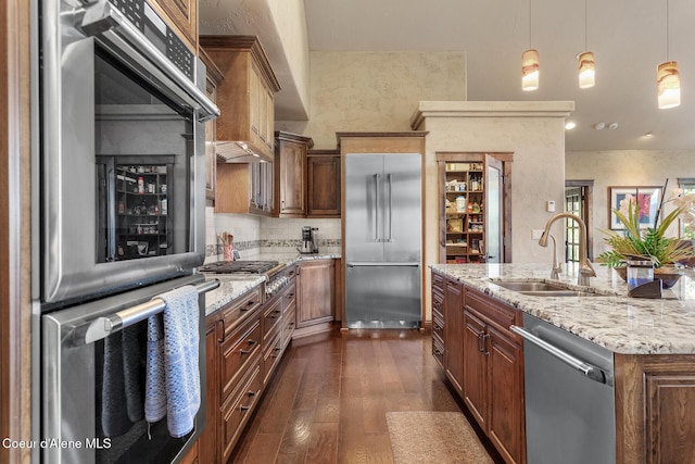 1122 S Four Winds Rd, Coeur Dalene, ID 83814 - kitchen with appliances with stainless steel finishes, dark wood-style flooring, a sink, and light stone countertops