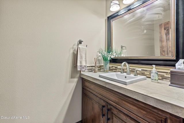1122 S Four Winds Rd, Coeur Dalene, ID 83814 - bathroom featuring vanity and decorative backsplash