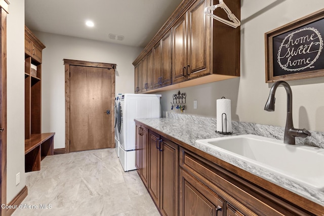 1122 S Four Winds Rd, Coeur Dalene, ID 83814 - laundry area with a sink, visible vents, cabinet space, and separate washer and dryer