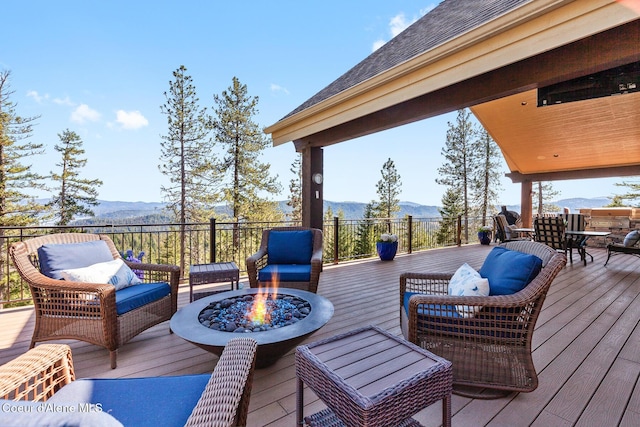 1122 S Four Winds Rd, Coeur Dalene, ID 83814 - deck with a mountain view and an outdoor living space with a fire pit