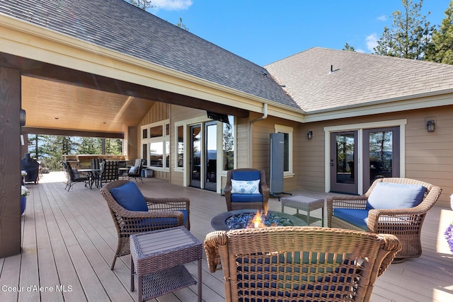 1122 S Four Winds Rd, Coeur Dalene, ID 83814 - deck featuring outdoor dining space and an outdoor living space with a fire pit