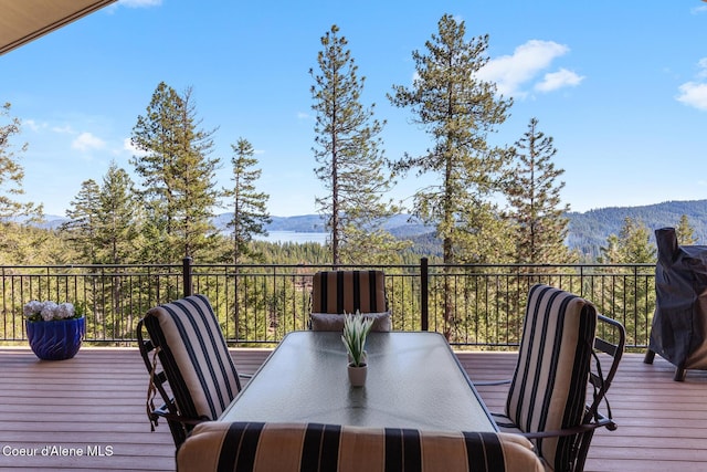 1122 S Four Winds Rd, Coeur Dalene, ID 83814 - deck featuring a wooded view, a mountain view, and outdoor dining area