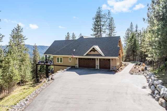 1122 S Four Winds Rd, Coeur Dalene, ID 83814 - rustic home with roof with shingles, aphalt driveway, a garage, and stone siding