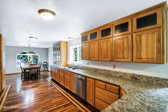 234 Stoneridge Rd, Blanchard, ID 83804 - kitchen with stainless steel dishwasher, brown cabinetry, and a sink