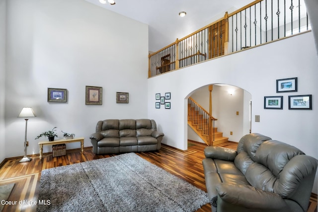 234 Stoneridge Rd, Blanchard, ID 83804 - living room featuring arched walkways, wood finished floors, a high ceiling, and stairway