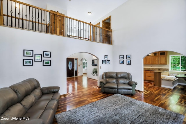 234 Stoneridge Rd, Blanchard, ID 83804 - living area featuring baseboards, arched walkways, and dark wood-style floors
