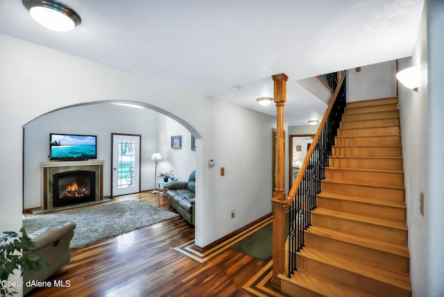 234 Stoneridge Rd, Blanchard, ID 83804 - interior space featuring arched walkways, a fireplace, baseboards, and wood finished floors