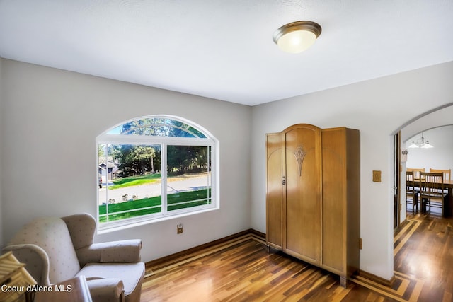 234 Stoneridge Rd, Blanchard, ID 83804 - sitting room featuring baseboards, arched walkways, and wood finished floors