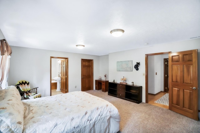 234 Stoneridge Rd, Blanchard, ID 83804 - bedroom with visible vents, light colored carpet, and ensuite bathroom