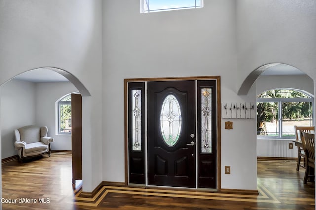234 Stoneridge Rd, Blanchard, ID 83804 - entryway featuring arched walkways, plenty of natural light, baseboards, and wood finished floors