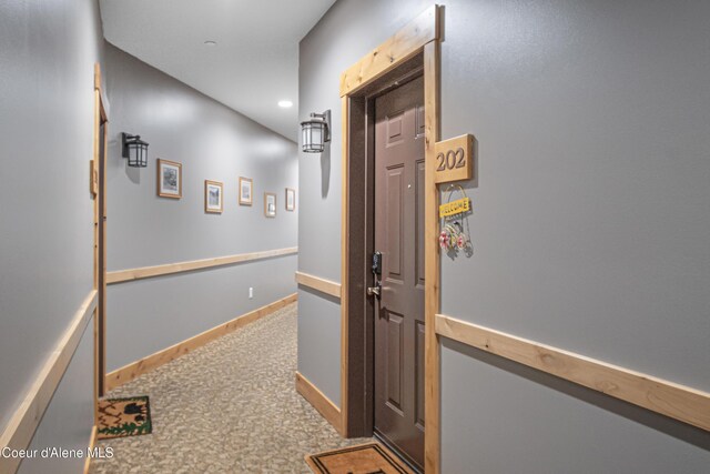 hallway with recessed lighting, carpet, and baseboards