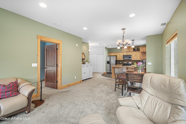 living area with light colored carpet, an inviting chandelier, visible vents, and recessed lighting