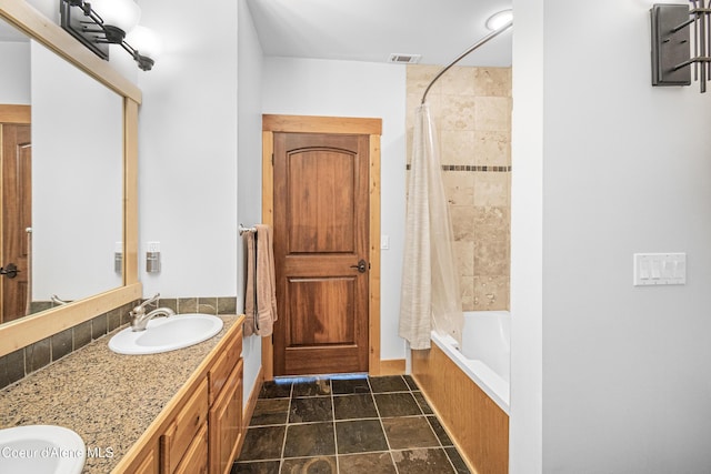 full bath with shower / tub combo, double vanity, a sink, and visible vents