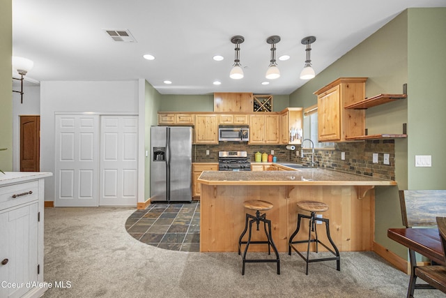 kitchen with backsplash, visible vents, dark carpet, appliances with stainless steel finishes, and a sink