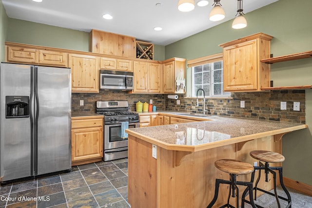 kitchen featuring stainless steel appliances, tile countertops, light brown cabinets, and a sink