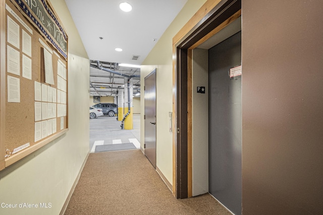 hallway featuring elevator, visible vents, baseboards, carpet floors, and recessed lighting
