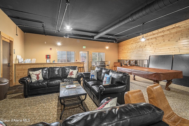 living room featuring wooden walls, carpet floors, and pool table