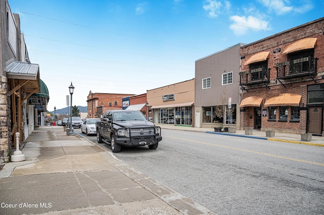 view of road with sidewalks, curbs, and street lighting