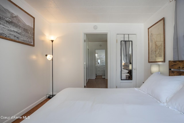 bedroom with a closet and baseboards