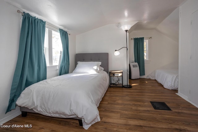 bedroom featuring visible vents, wood finished floors, and lofted ceiling