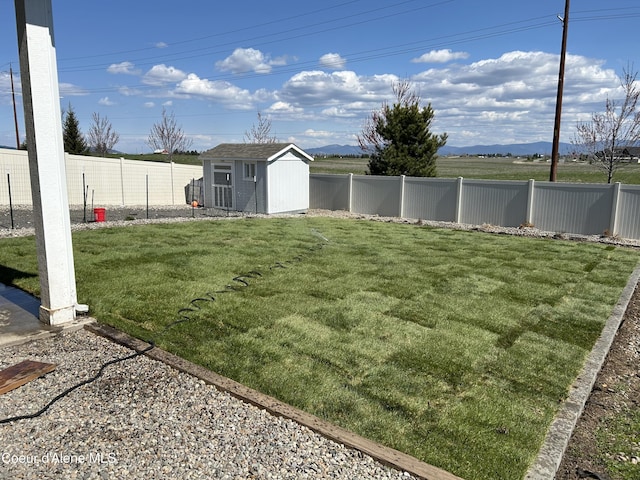 view of yard featuring a fenced backyard, a shed, and an outdoor structure