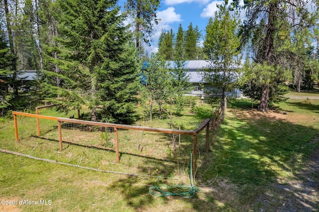 view of gate with a lawn