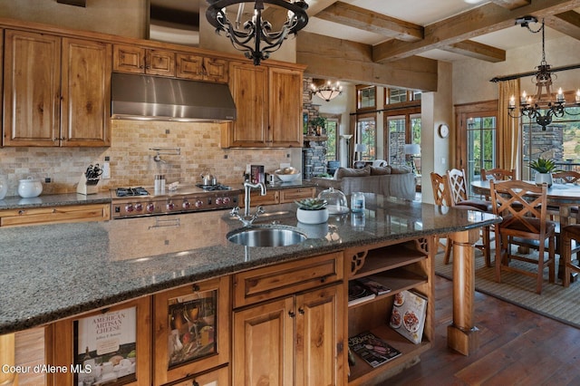 16917 S Basalt Dr, Coeur Dalene, ID 83814 - kitchen with ventilation hood, a chandelier, dark wood finished floors, stainless steel gas cooktop, and brown cabinets