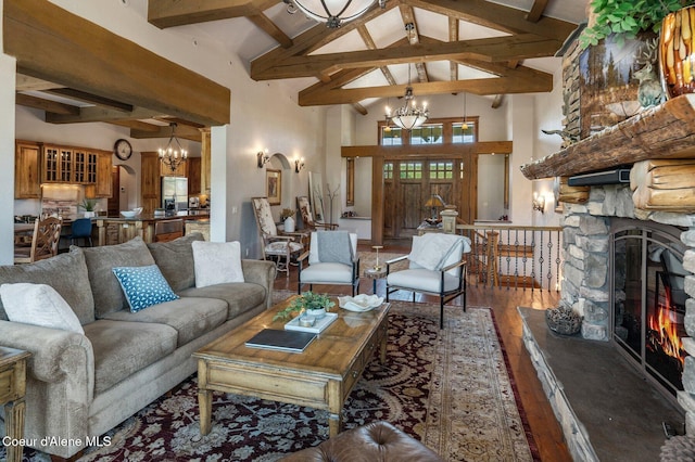 16917 S Basalt Dr, Coeur Dalene, ID 83814 - living area featuring a chandelier, wood-type flooring, beam ceiling, high vaulted ceiling, and a stone fireplace