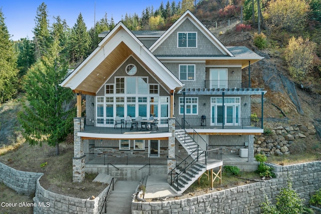 back of property with a patio area, stairway, and a balcony