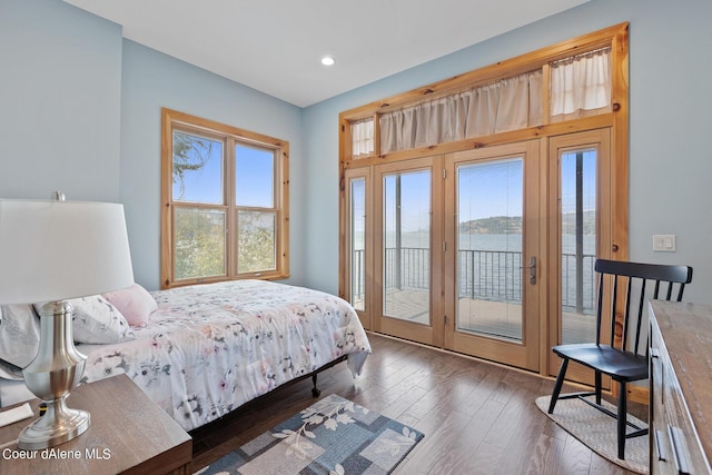 bedroom with access to outside, hardwood / wood-style floors, and recessed lighting
