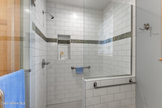 full bath featuring tiled shower