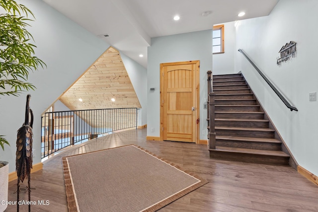 stairs with visible vents, baseboards, recessed lighting, and wood finished floors