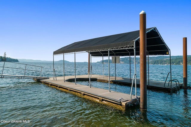 dock area featuring a water and mountain view