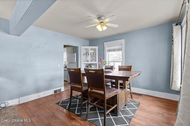 315 S 5th St, Saint Maries, ID 83861 - dining area with visible vents, baseboards, wood finished floors, and ceiling fan