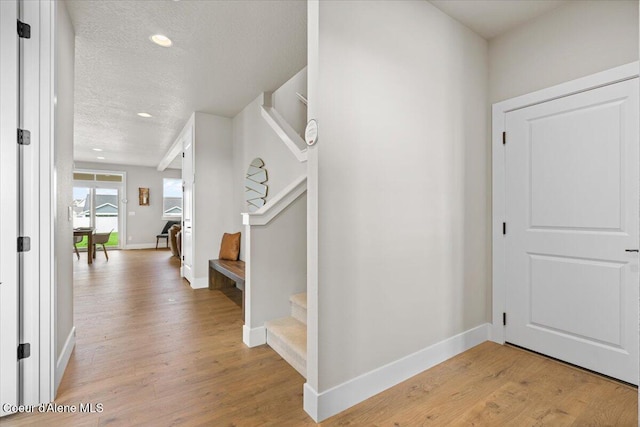 3402 N Cyprus Fox Loop, Post Falls, ID 83854 - entrance foyer with light wood-type flooring, a textured ceiling, baseboards, and stairway
