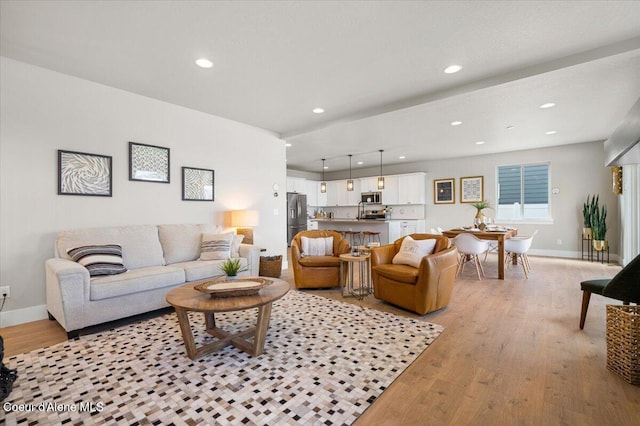 3402 N Cyprus Fox Loop, Post Falls, ID 83854 - living room with light wood-style floors, baseboards, and recessed lighting