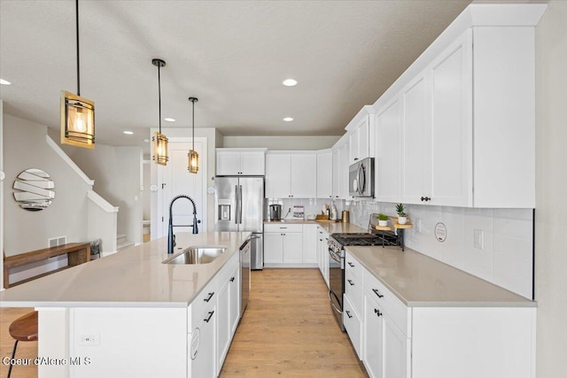 3402 N Cyprus Fox Loop, Post Falls, ID 83854 - kitchen featuring backsplash, a kitchen bar, a sink, stainless steel appliances, and recessed lighting