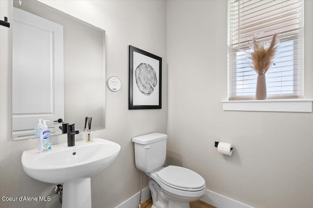 3402 N Cyprus Fox Loop, Post Falls, ID 83854 - bathroom featuring toilet, baseboards, and a sink