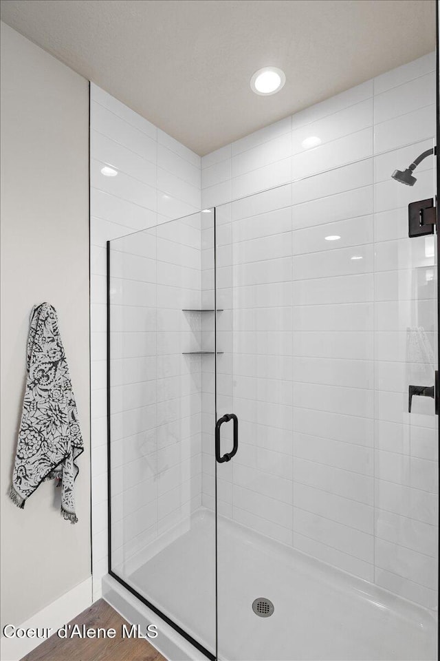 3402 N Cyprus Fox Loop, Post Falls, ID 83854 - bathroom with baseboards, a stall shower, recessed lighting, and wood finished floors