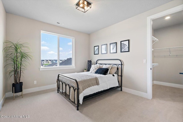 3402 N Cyprus Fox Loop, Post Falls, ID 83854 - bedroom with baseboards, visible vents, a spacious closet, and carpet