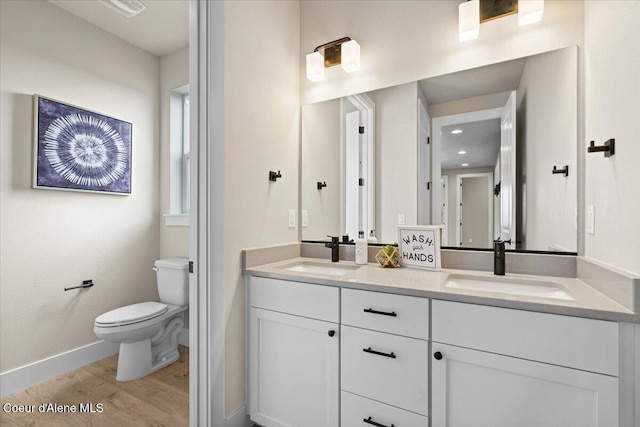 3402 N Cyprus Fox Loop, Post Falls, ID 83854 - full bathroom with toilet, baseboards, a sink, and wood finished floors