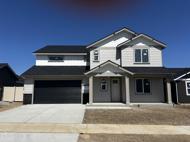 3402 N Cyprus Fox Loop, Post Falls, ID 83854 - traditional home featuring an attached garage, roof with shingles, board and batten siding, a porch, and driveway