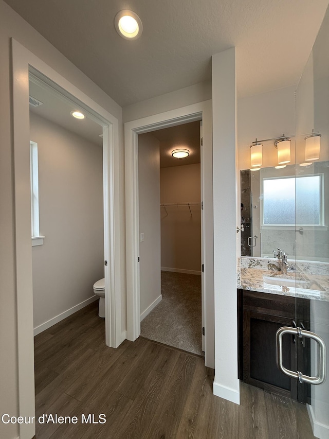 3402 N Cyprus Fox Loop, Post Falls, ID 83854 - full bath featuring wood finished floors, vanity, and a walk in closet