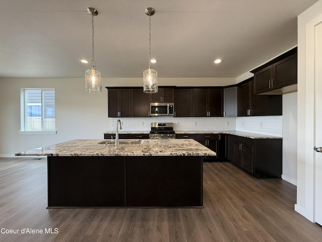 3402 N Cyprus Fox Loop, Post Falls, ID 83854 - kitchen featuring stainless steel appliances, backsplash, dark wood-style flooring, light stone counters, and recessed lighting