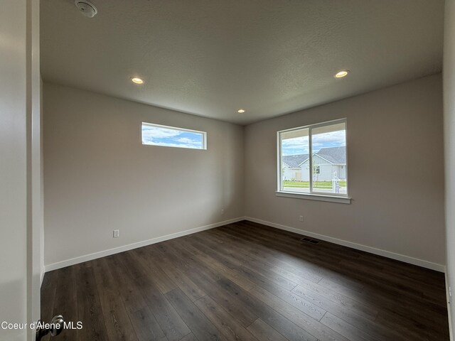 3402 N Cyprus Fox Loop, Post Falls, ID 83854 - unfurnished room with a smoke detector, dark wood-type flooring, and recessed lighting