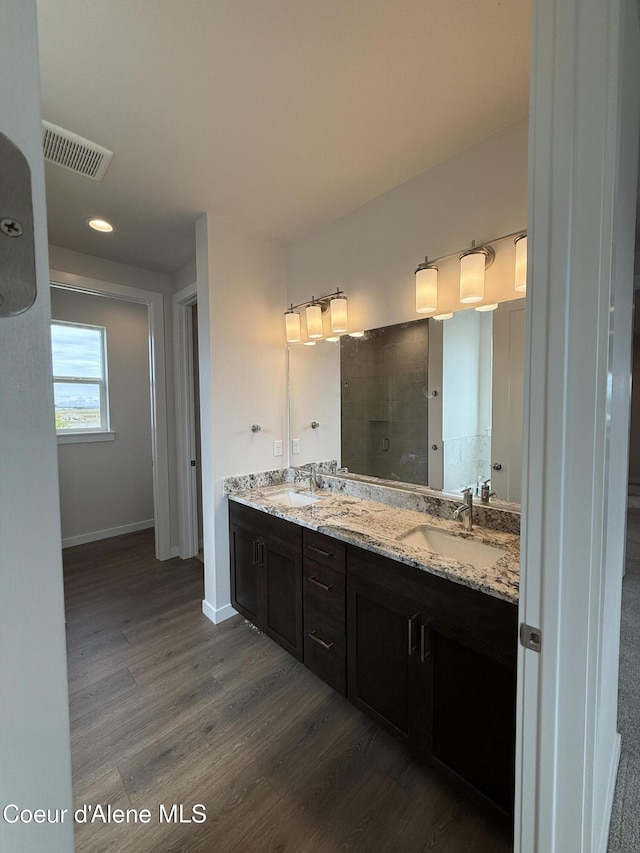 3402 N Cyprus Fox Loop, Post Falls, ID 83854 - full bathroom with double vanity, wood finished floors, recessed lighting, and a shower