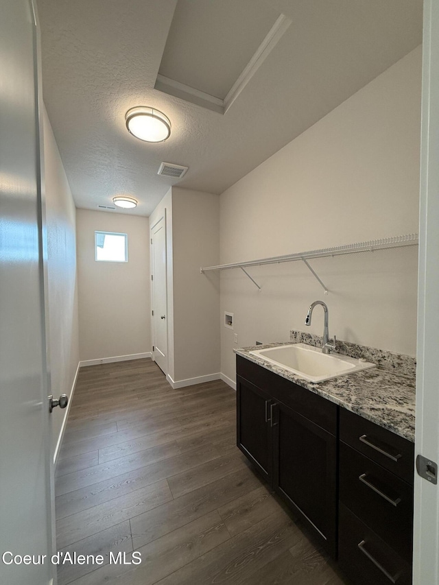3402 N Cyprus Fox Loop, Post Falls, ID 83854 - washroom featuring washer hookup, dark wood-style flooring, and a textured ceiling