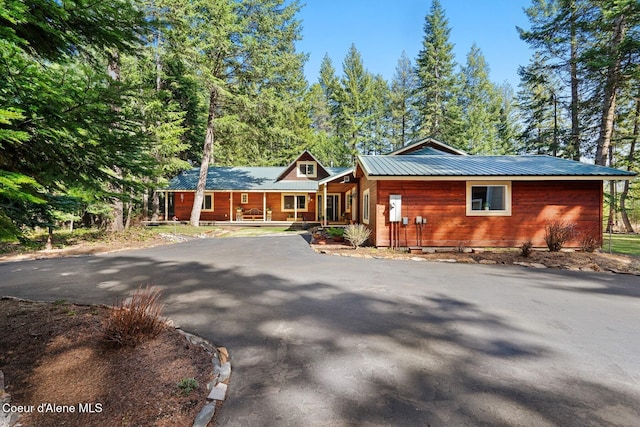 view of front of home with a porch and metal roof